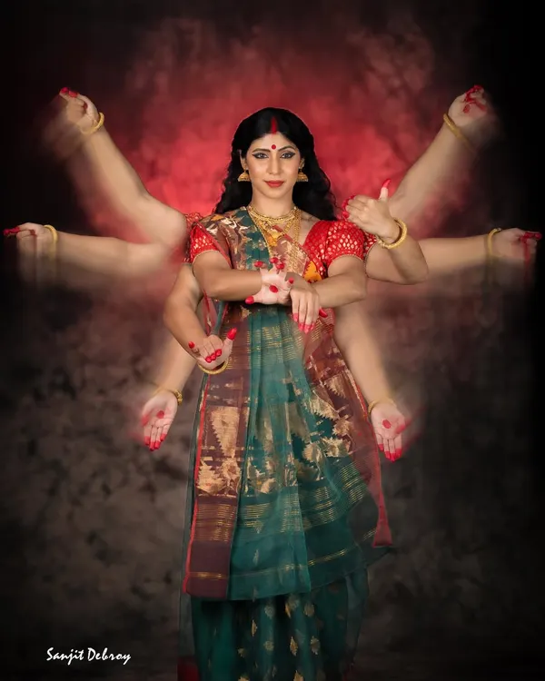 The final image of the Goddess, with multiple arms representing her 'Shakti' or power. This photo from 'The Creation of a Goddess' is the culmination of the narrative, showing the complete transformation from humble clay to the divine.