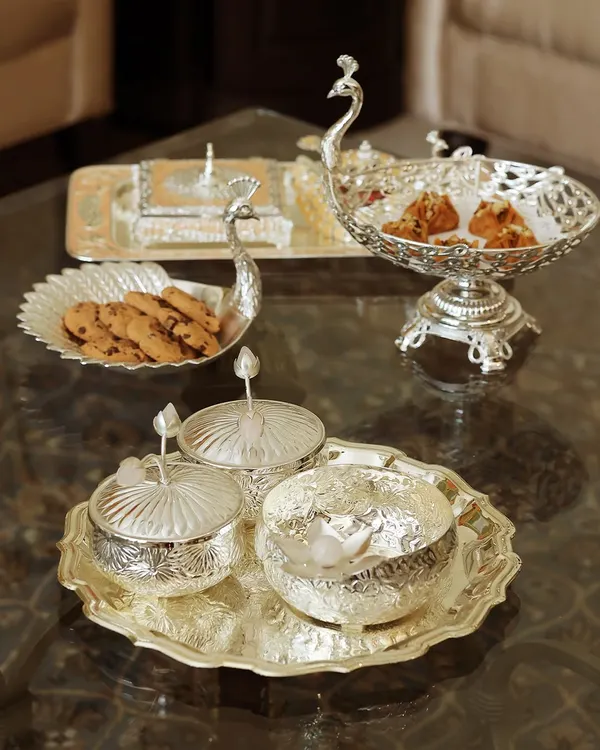 My Mijaaz collection is a tribute to Mughal grandeur, and this peacock-themed silver serveware set is its crown jewel. Each piece, from the serving tray to the lidded bowls, is crafted to bring a sense of royal artistry to your table.