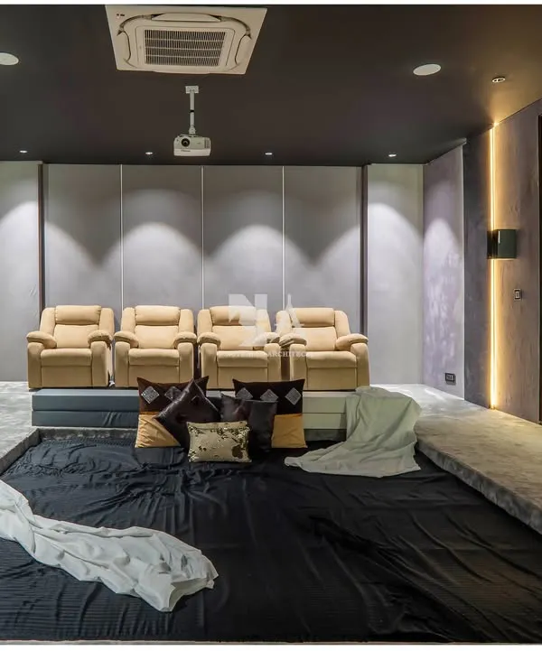 A full view of our custom home theater, designed for the ultimate cinematic experience. The room features plush leather recliners for premium seating, complemented by a large, informal dug-out area in the front for casual lounging.