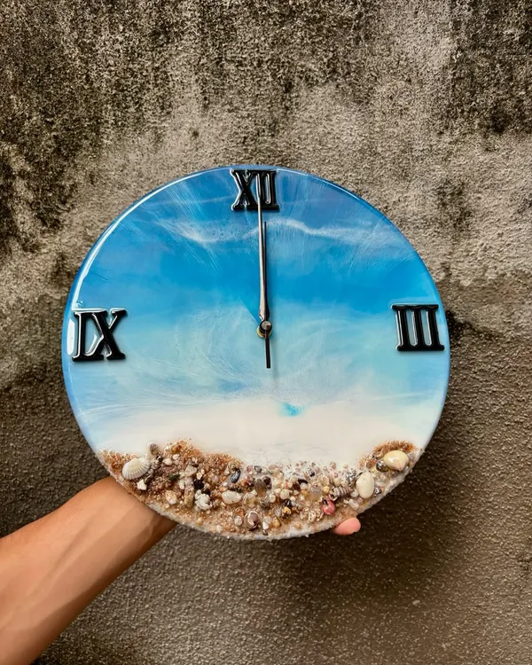 Here’s one of my most popular creations, the ocean-themed resin wall clock. I use real sand and shells to create a miniature beach scene, and the layered resin waves give it a realistic 3D look. It's a beautiful piece of functional art for any home.