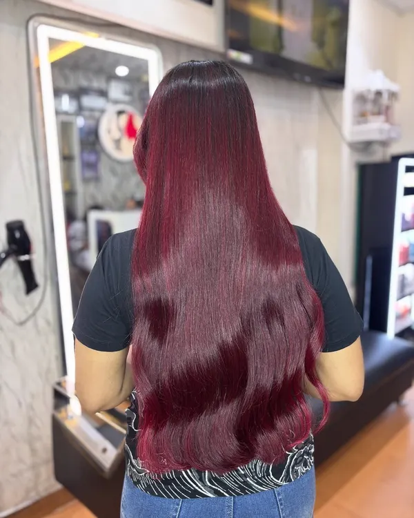 This cherry red hair is pure magic. The color is incredibly vibrant and glossy, making it the perfect bold choice for the festive Christmas season. Red is not just a color, it's a mood.