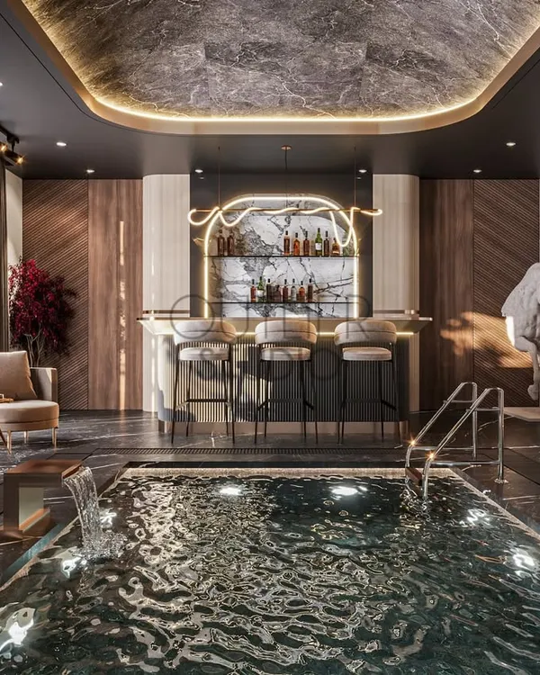 This is where your home becomes the ultimate private club. We designed this entertainment area with an indoor pool and a fully-stocked bar to be the perfect space for both relaxation and socializing, blending dark marble, warm wood, and sophisticated lighting.