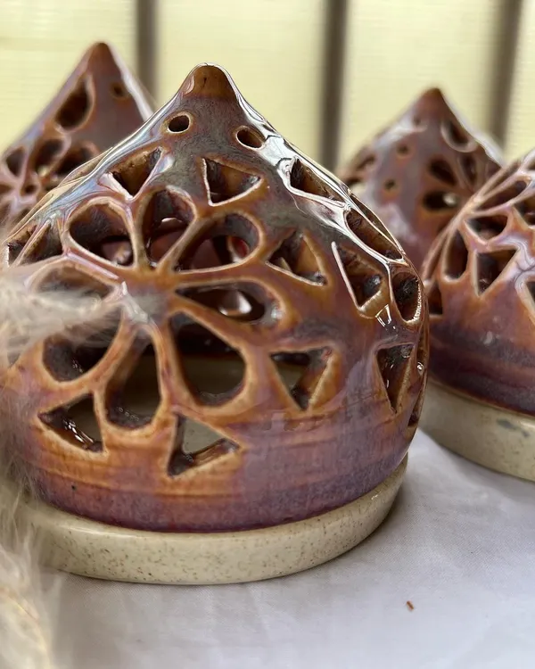 Our handmade ceramic tea light holders are perfect for the festive season. These intricate pieces create a beautiful, warm glow for Diwali.