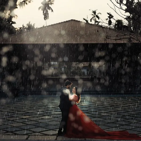 A cinematic pre-wedding moment captured in the rain. We embrace the elements to create dramatic, film-like scenes that feel like they are straight out of a movie, focusing on the connection you share, no matter the weather.