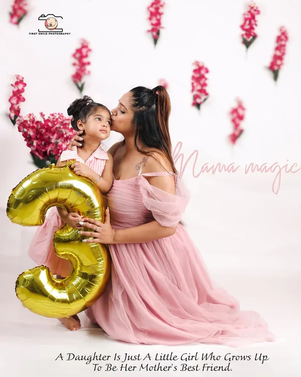 A tender moment between a mother and her daughter celebrating her third birthday. The golden '3' balloon marks the special occasion in this beautiful studio portrait.