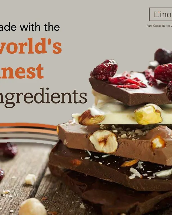 A stunning stack of our artisanal chocolate bars, featuring milk chocolate with hazelnuts, white chocolate with pistachios, and dark chocolate with cranberries. This is the heart of what we do: using only the world's finest ingredients like authentic Belgian couverture chocolate to create an intensely gratifying experience.