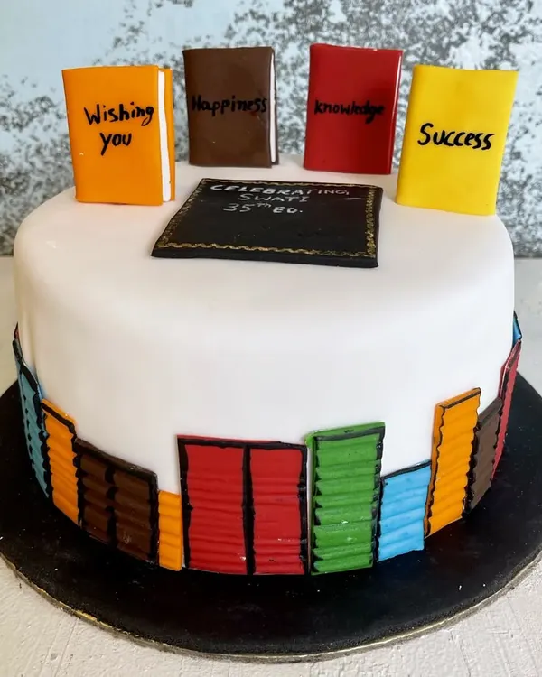 The perfect cake for the bookworm in your life. This design features a library of edible books with custom titles like "Happiness" and "Success," celebrating a 35th birthday.
