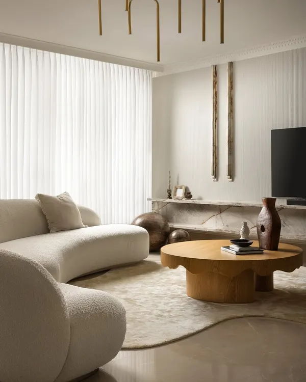 This living room from our Ecru Maison project is a study in quiet sophistication. We used a cloud-like boucle sofa, a sculpted oak coffee table, and veined marble to create a serene, intimate space where every detail feels intentional and every form is organic.