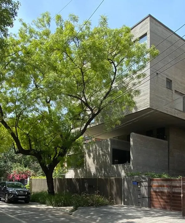 The Jenga House in New Delhi, viewed from the street. The design's name comes from its stacked, cantilevered concrete forms that create a powerful sculptural presence within its urban context.