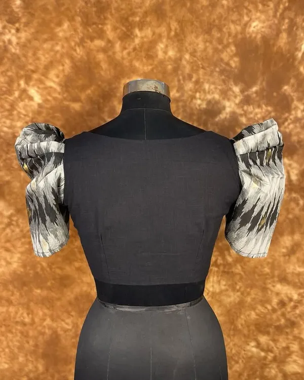 Classy and bold. This black blouse features dramatic puff sleeves in a contrasting print and a flattering sweetheart neckline. The front hook closure ensures a perfect, seamless fit.