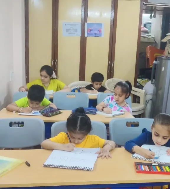 A classroom buzzing with creativity. Our young artists are deeply focused on their drawings, learning sketching and coloring techniques with guidance from our art instructors.