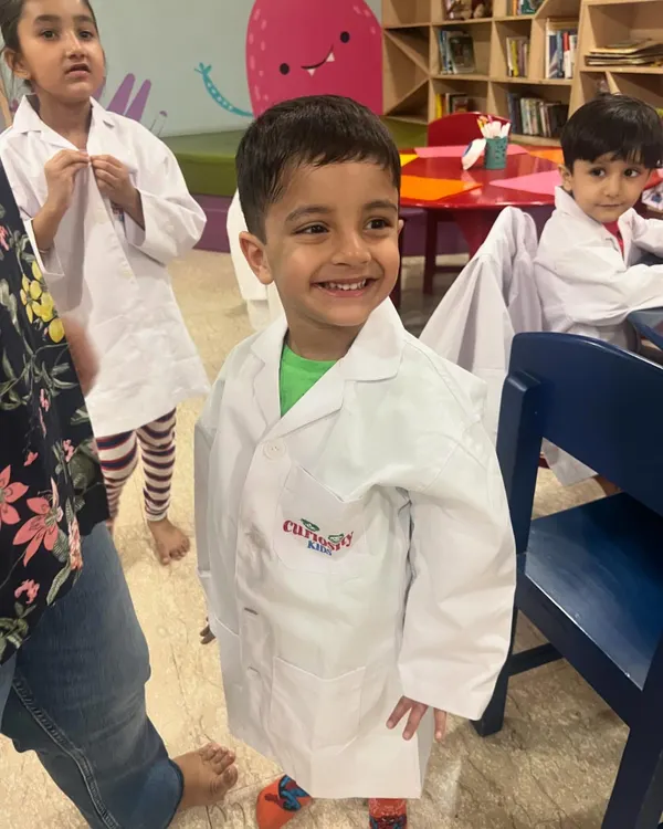 This happy face says it all! Our science camps let kids explore their curiosity in a fun, interactive way, starting with their very own lab coat.