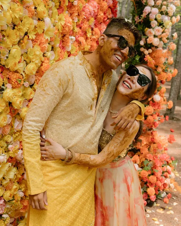 This is what I call sunshine chic. For this haldi, we created a stunning floral wall with an ombre of marigolds and roses, a modern twist on a traditional ceremony that perfectly matched the couple's vibrant energy.