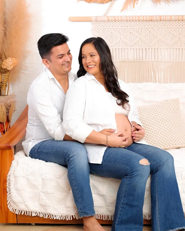 A perfect example of a relaxed casual session. This couple, dressed in simple jeans and white shirts, shares a laugh in my cozy, boho-themed studio.