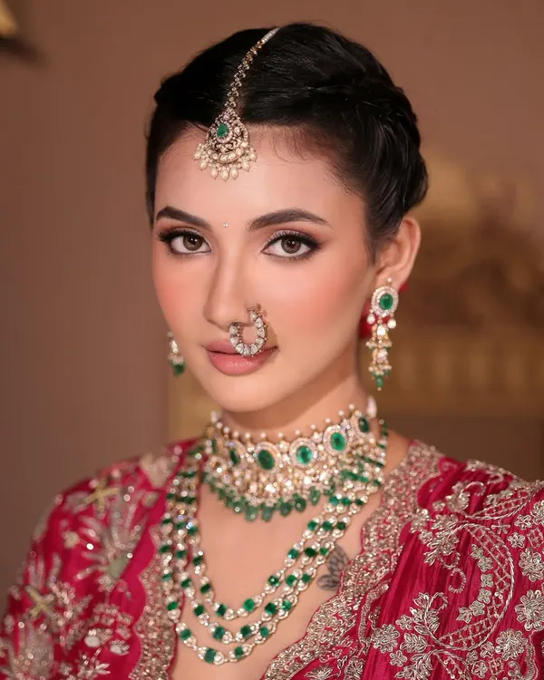 A regal and timeless Indian bridal look, focusing on luminous skin and softly defined eyes. This makeup is designed to feel as royal as it looks, perfect for the bride who wants classic elegance.