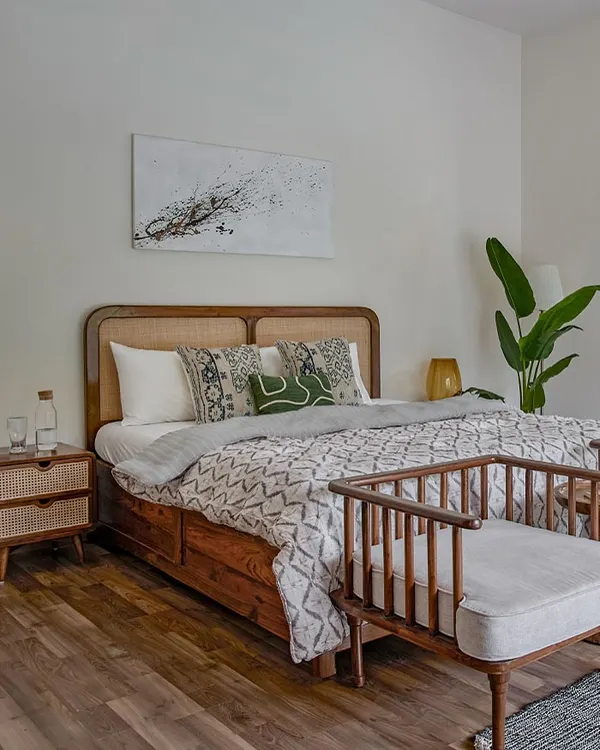 A beautiful bedroom setting featuring my mid-century modern bed with a curved cane and wood headboard. The matching cane nightstand completes this serene and stylish space.