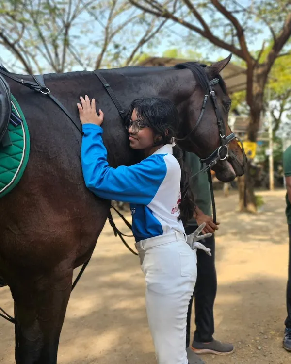 A quiet moment of connection between a rider and her horse. This bond, built on trust and mutual respect, is the foundation of all success in equestrian sports.