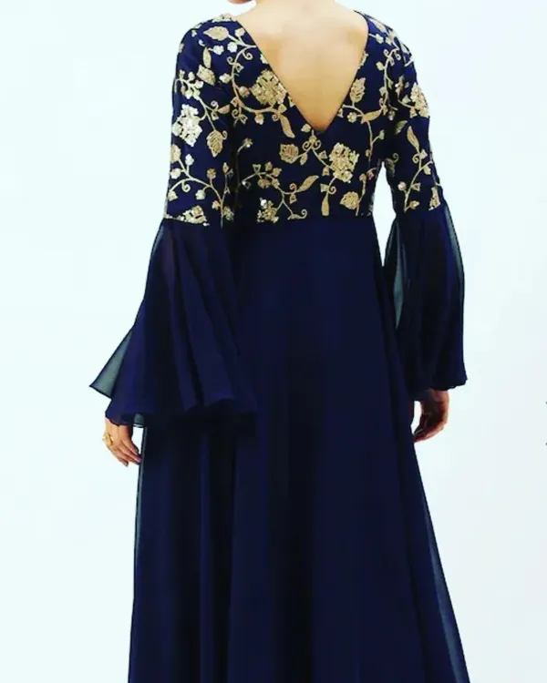 The back view of the navy blue georgette gown, showing the V-neckline and the continuation of the gold floral embroidery across the shoulders.