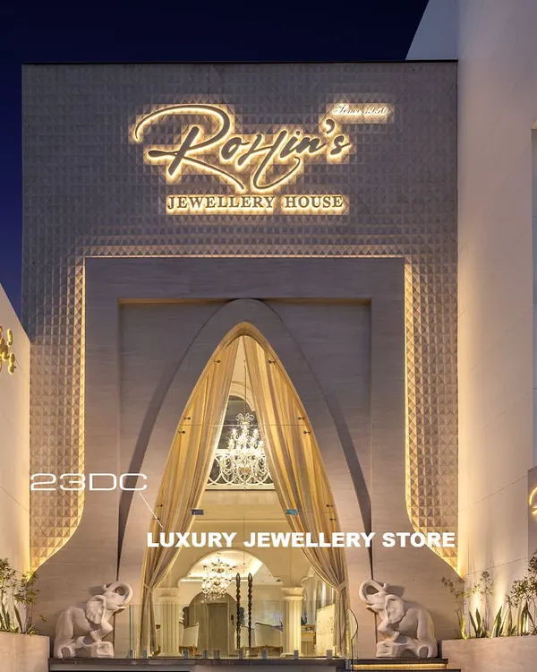 The entrance to this luxury jewellery house is designed to be a grand statement. A massive archway draped in fabric, flanked by elephant sculptures, and illuminated signage creates an inviting and opulent first impression for every client.