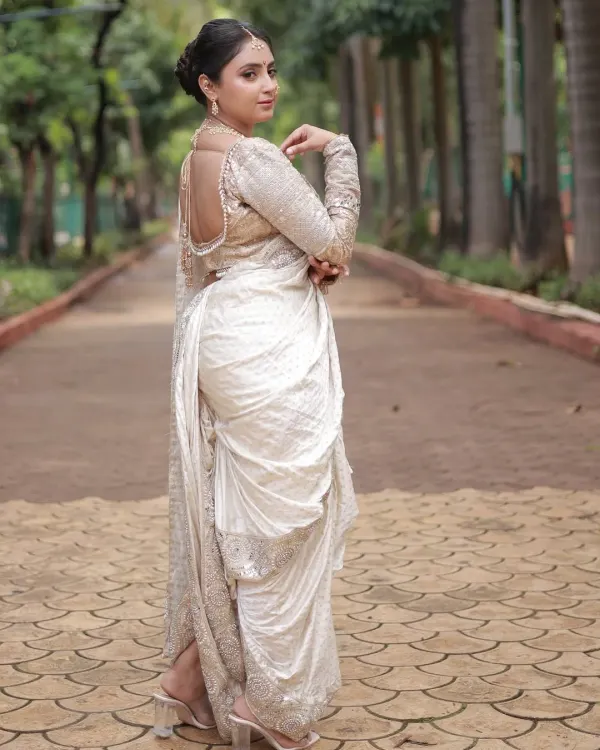 This is my pride and joy, a stunning white designer Nauvari saree. It represents my Maharashtrian roots and offers a modern, elegant take on our beautiful tradition. Perfect for the bride who wants something unique.