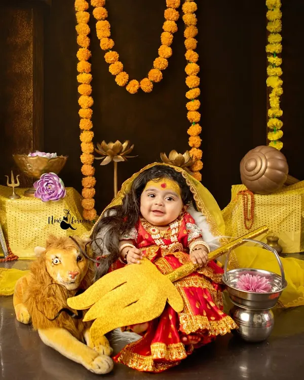 A masterpiece of our Navratri celebration, this little girl is transformed into a divine Durga. The detailed costume, props, and her innocent expression create a truly powerful portrait.