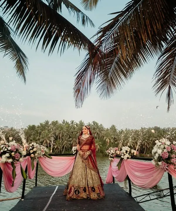 For a truly unforgettable bridal arrival, I designed this stunning waterside entrance. The bride stood poised against a backdrop of lush palm trees and shimmering pyrotechnics, creating a moment of pure drama and elegance.