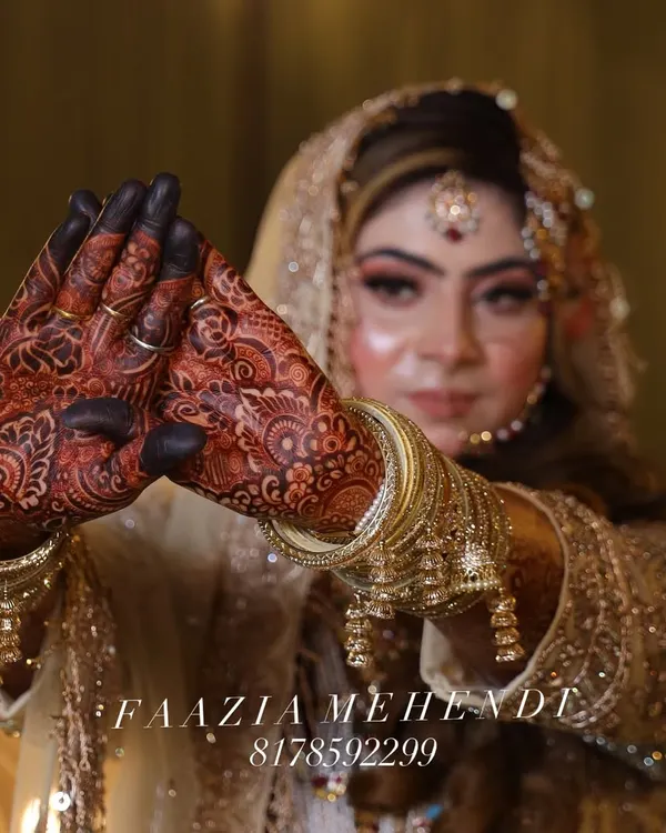 This is the result of all our mehnat and patience, beta. A happy bride with a deep, rich maroon henna stain that makes her special day even more beautiful. Alhumdulillah.