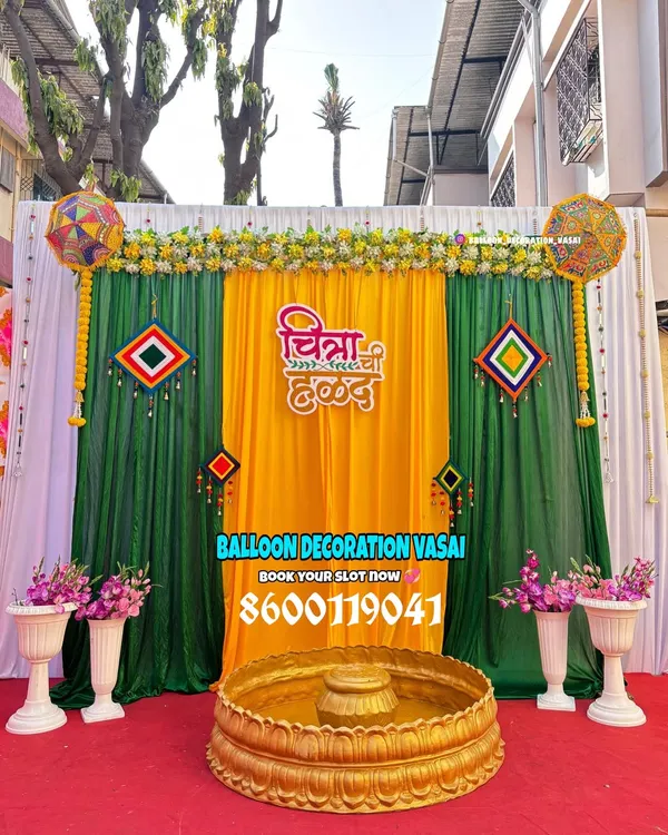 For a traditional Haldi ceremony, we use a classic combination of yellow and green drapes, marigold flowers, and personalized signage in Marathi for an authentic touch.