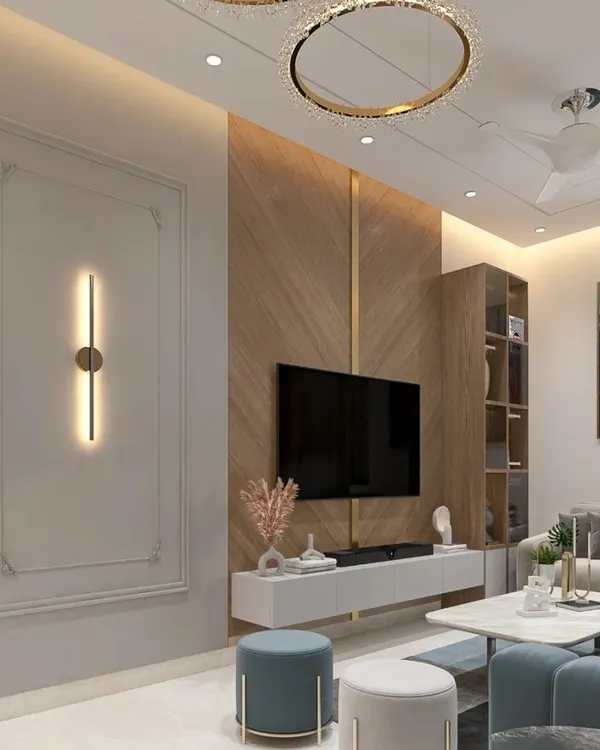 This living room combines a cool blue sofa with warm wood paneling and classic wall molding. We used a statement chandelier and modern wall sconces to create layers of light, making the space feel both cozy and sophisticated.