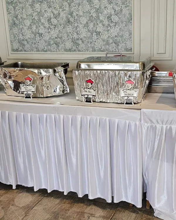 A clean and professional buffet setup for a football-themed birthday party. I provide everything from the food warmers to the table skirting.