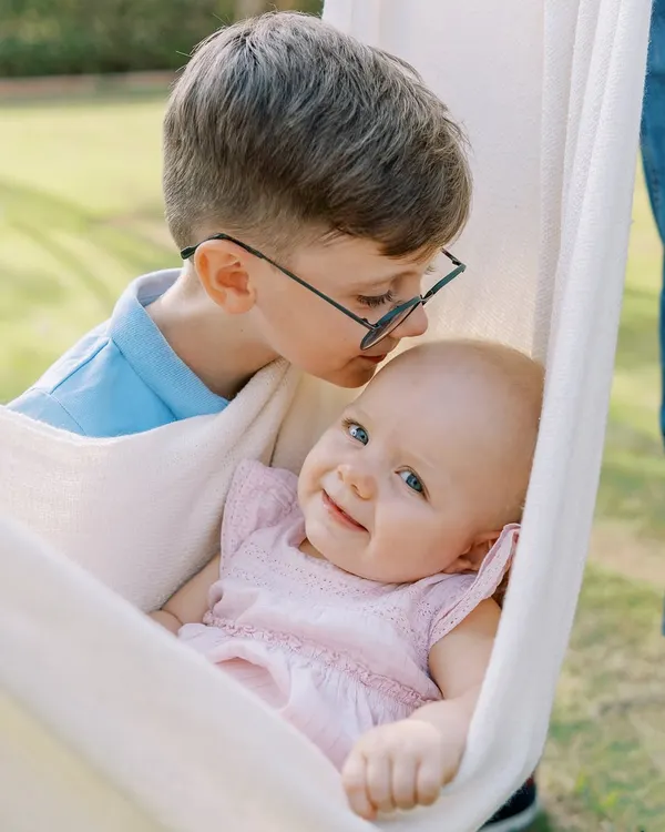 The gentle kiss of an older brother for his baby sister. These are the moments that melt my heart and create a timeless memory of sibling love.