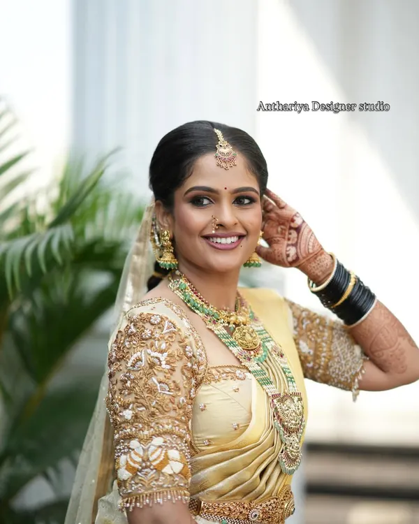 The radiant smile of our bride Monisha in her custom Anthariya wedding outfit. Her golden saree and heavily embroidered blouse were designed to make her feel as special as she is.