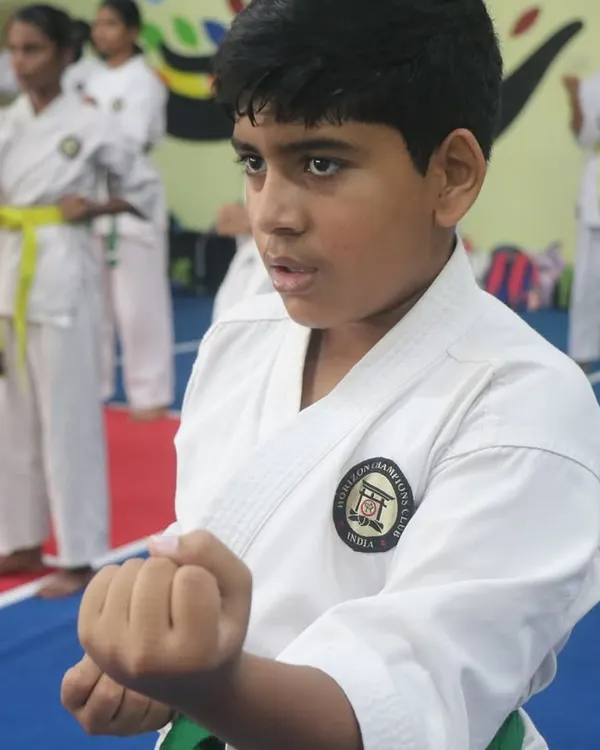 The look of pure focus. We teach our students that power comes not just from the body, but from a disciplined mind. This young warrior is practicing his basic stance and punch (Kihon).