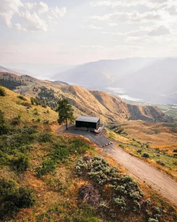 An aerial view of our modular home nestled in the hills. This design showcases how our structures can be placed in remote, beautiful locations, offering a perfect escape with minimal environmental impact.