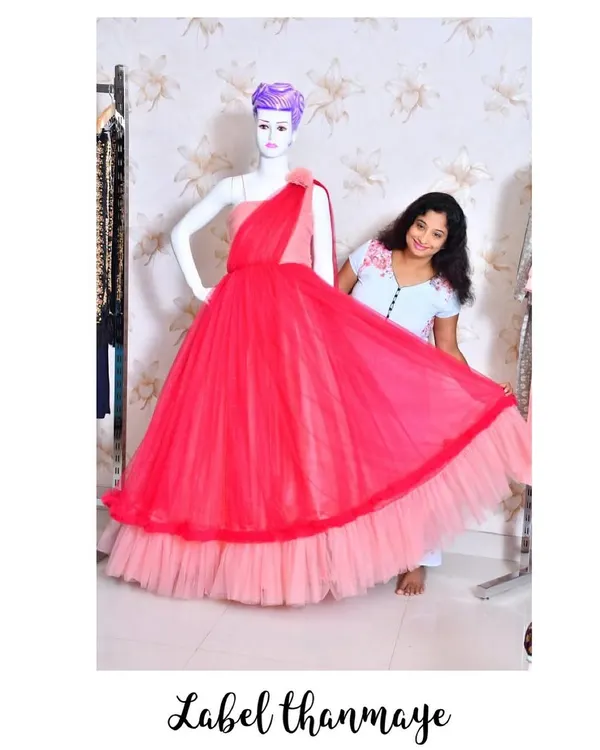 Here I am, adding the final touches to a two-tone red and pink gown in my studio.