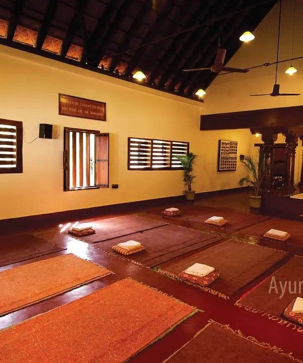 Our peaceful indoor yoga hall, prepared for a session. This dedicated space, with its traditional architecture and serene ambiance, is designed to help you find inner peace and harmony on the mat.