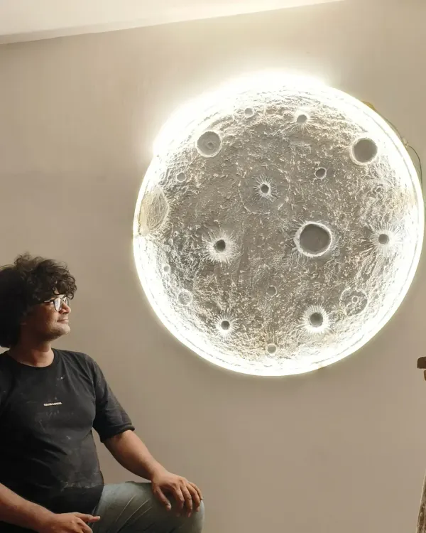 I am sitting next to a large, backlit 3D moon art piece, one of the most popular items we teach. This artwork can transform any room with its serene and realistic glow.