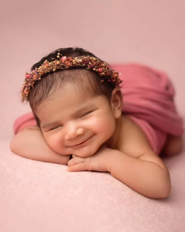 This is the kind of sleepy, peaceful smile that I live to capture. This little girl was an absolute dream, and her portrait shows the soft, artistic style I bring to every newborn session.