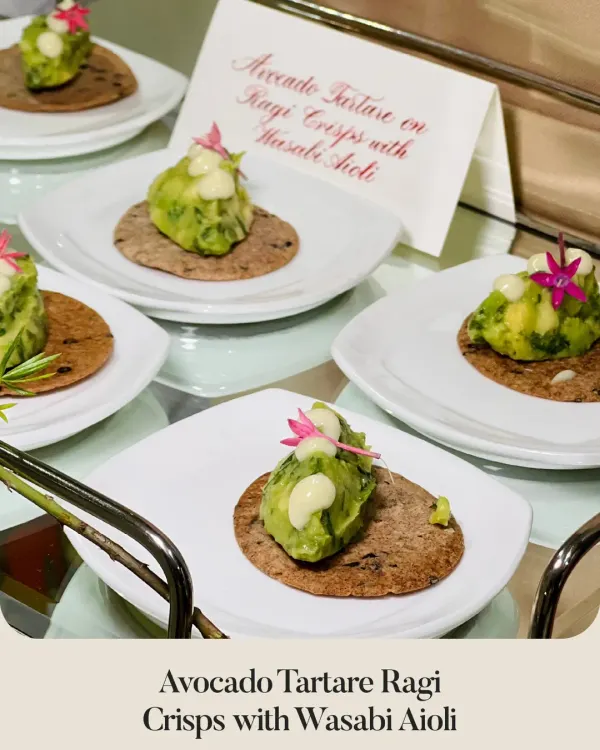My Avocado Tartare on Ragi Crisps with Wasabi Aioli. This bite-sized canapé combines creamy avocado with the earthy crunch of ragi and a kick of wasabi, garnished with an edible flower.