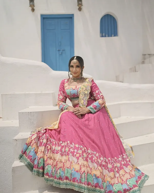 A Navratri series photoshoot with a vibrant, festive theme. The makeup is bright and celebratory, matching the colorful lehenga and the joyous spirit of the festival.