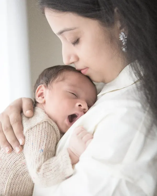 There is nothing as pure as the bond between a mother and her newborn. I focus on capturing these quiet, authentic moments of connection, like this sleepy yawn, that you will cherish forever. These early days are fleeting, and my newborn sessions are designed to preserve them beautifully.