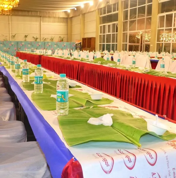The calm before the feast. This shows our meticulous preparation for a large-scale pangat service, with banana leaves and water bottles neatly arranged for hundreds of guests at an engagement event.