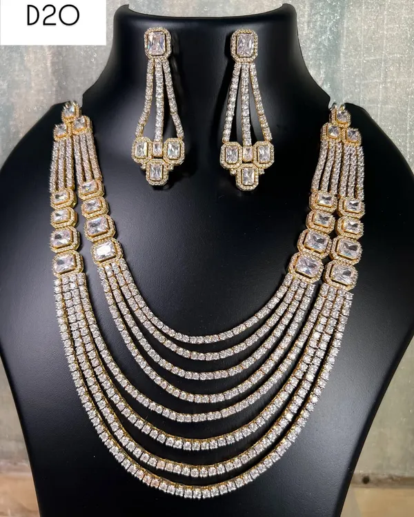 This is a stunning multi-layered American diamond necklace in a silver and gold dual-tone finish. It's a grand piece to rent for a wedding or reception, giving you a full and luxurious look.