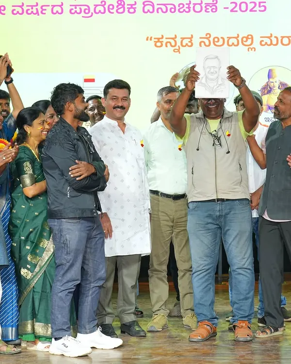 Presenting a hand-drawn sketch to the esteemed director T.S. Nagabharana at a Kannada cultural event. It's a joy to capture the portraits of people who have contributed so much to our culture.