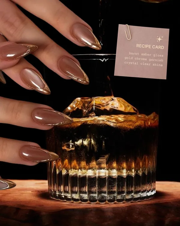 Not on the rocks, but definitely on the nails. This fall cocktail-inspired set features "burnt amber glass" nails with a gold chrome garnish.