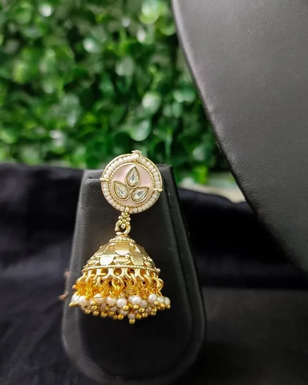 A delicate and pretty jhumka with pink enamel work on the top, perfect for a daytime event.
