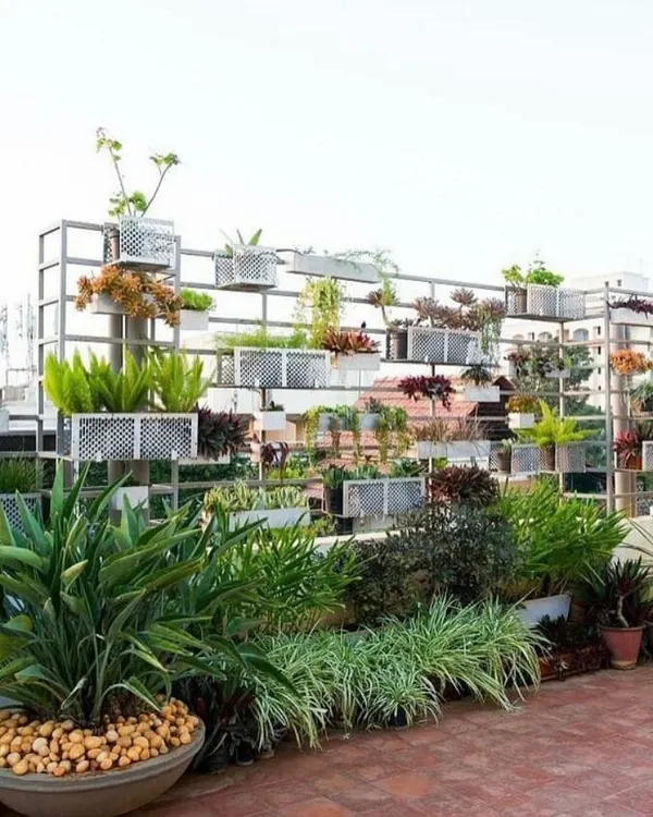 This custom modular green wall was designed for a commercial terrace to provide privacy and a strong visual element. The metal grid and planter system allows for a diverse mix of plants, turning a plain wall into a vertical garden.