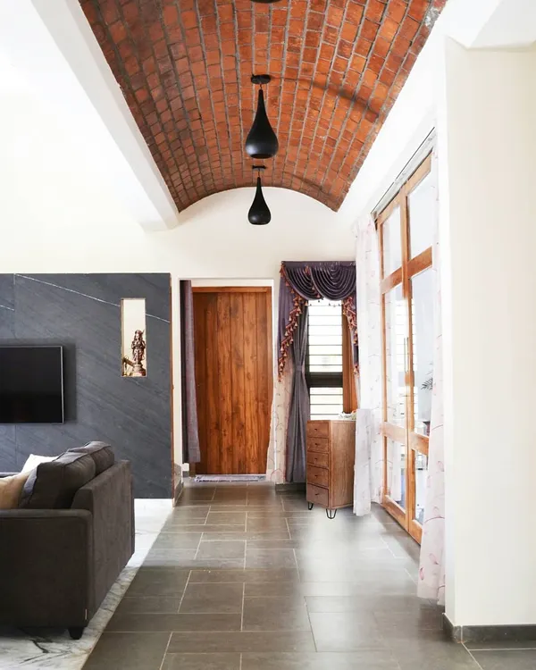 An exposed brick vault ceiling creates a stunning architectural feature in the main hallway. This technique adds warmth, texture, and a sense of movement to the space.