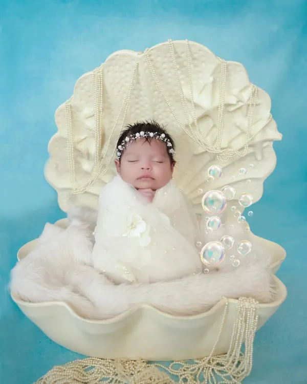 We believe every baby is a precious pearl. This newborn photoshoot captures that serene innocence, with our custom-designed seashell prop and soft, gentle lighting ensuring your baby is safe, comfortable, and beautifully photographed.