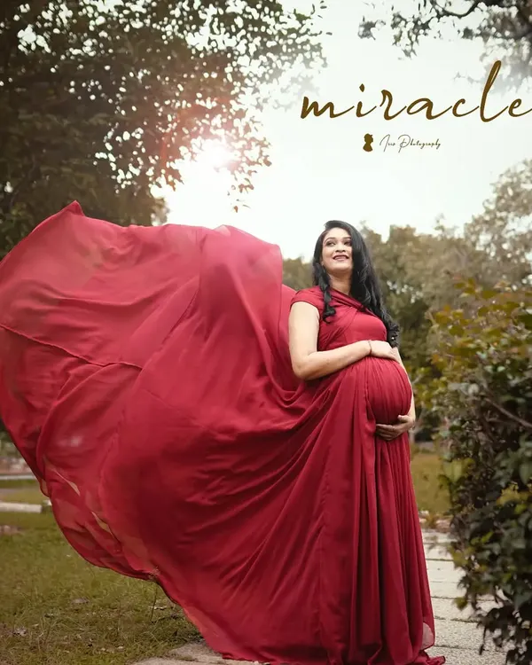 A magical maternity shoot moment. The client is wearing a flowing red gown, and I created a soft, natural makeup look to match the dreamy vibe.